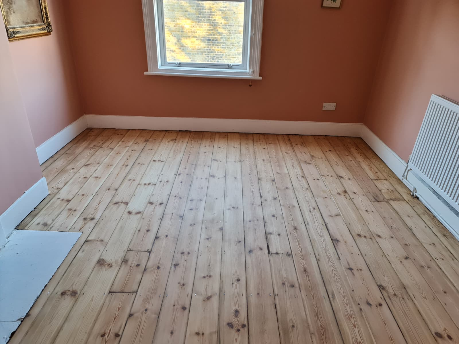 Wide-plank oak floor sanding in London townhouse