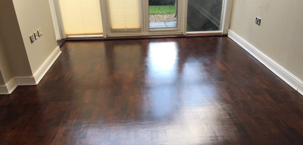 Dark wooden floor in a bright living space