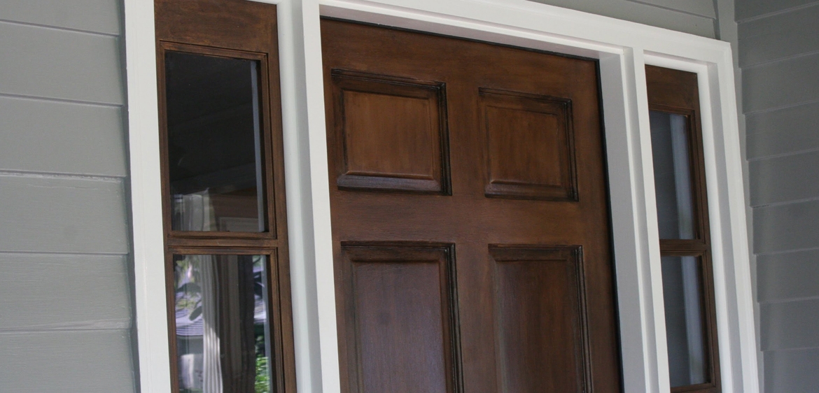 Panelled dark brown wooden entry door restored